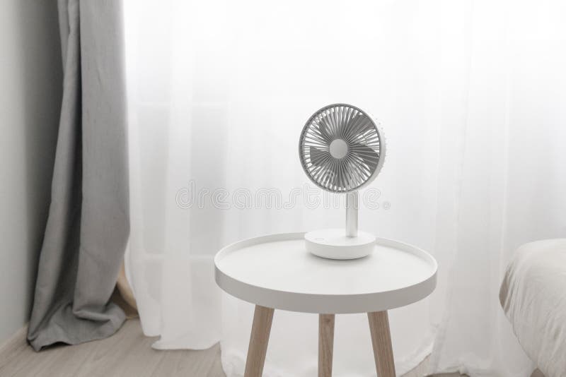 Modern Electric Portable Fan in Bedroom. Mini Portable Cooler. Space