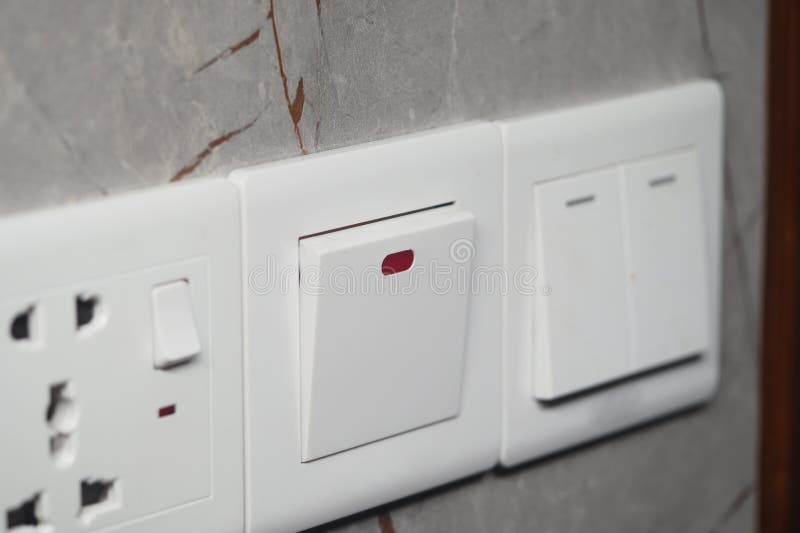 Modern electrical switch and outlet on textured wall stock images