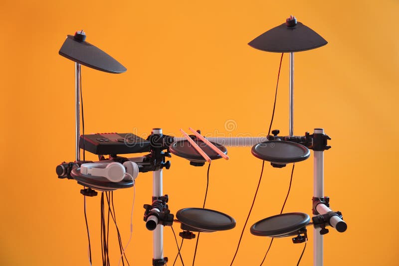Modern Electronic Drum Kit on Orange Background. Musical Instrument