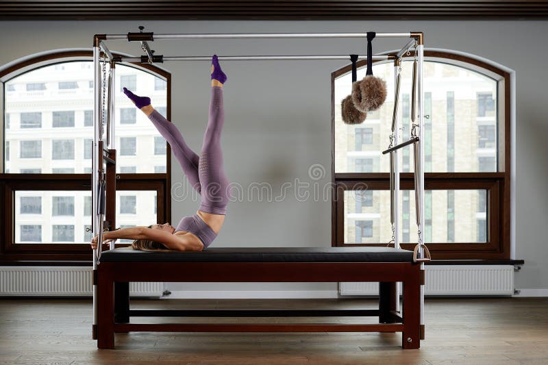 Modern equipment Cadilac reformer for Pilates in the gym, Concept of health and rehabilitation, instructor performs