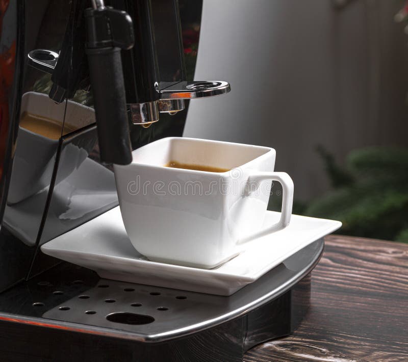 Modern Espresso Coffee Machine with a Cup of Coffee Closeup. Espresso