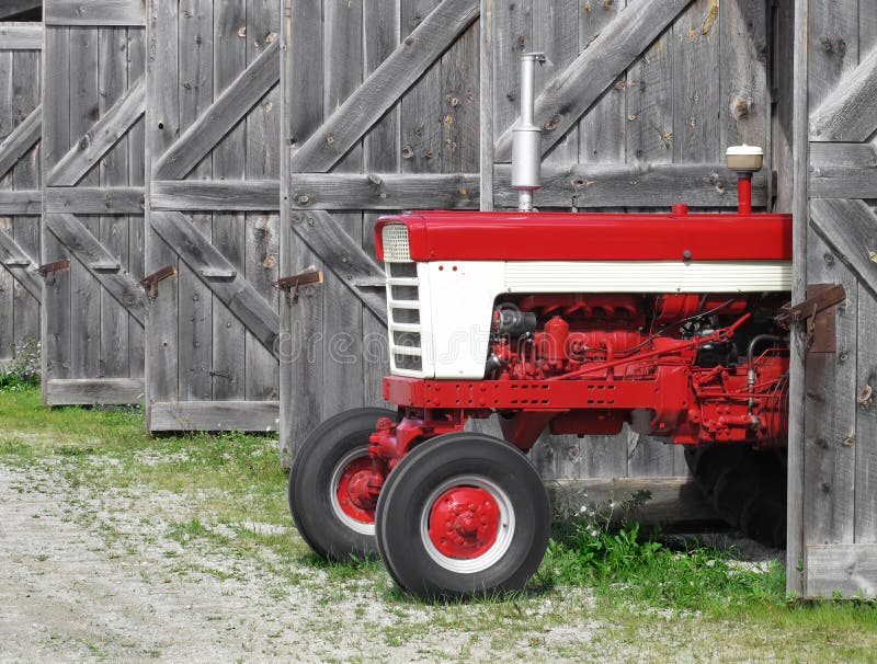 Modern farm tractor in an old shed