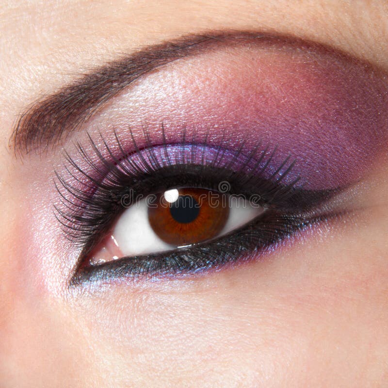 Modern fashion violet makeup of a female eye royalty free stock image