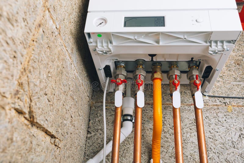 Modern gas boiler bottom piping, independent heating system royalty free stock photo