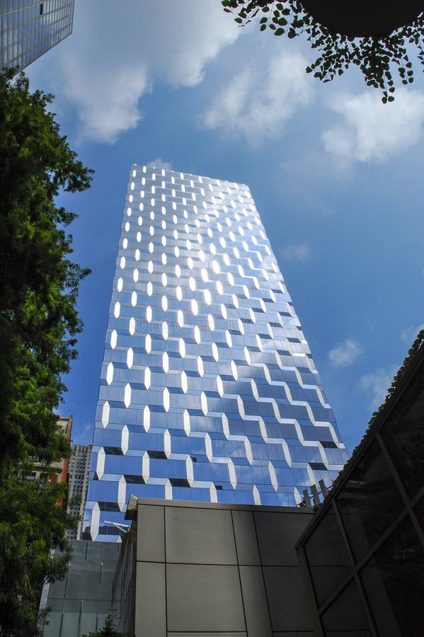 Modern Glass Building Reflecting Blue Sky