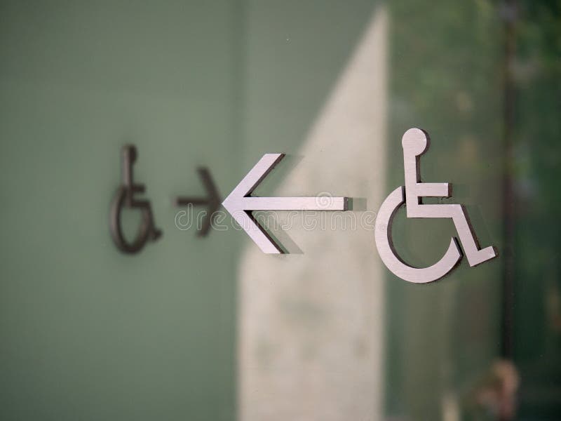 Modern handicap disabled logo pointing to left with another creating path royalty free stock image