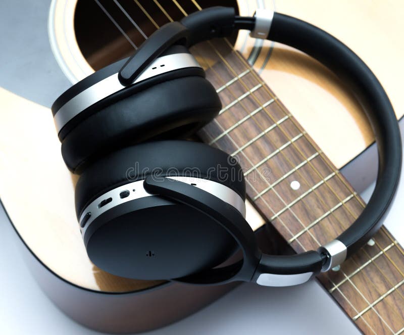 Modern Headphones and Part of an Acoustic Guitar Stock Photo Image of