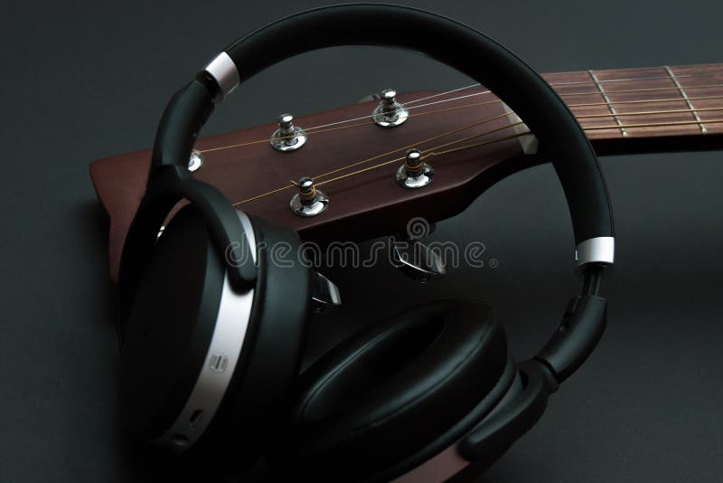 Modern Headphones and Part of an Acoustic Guitar Stock Image Image of