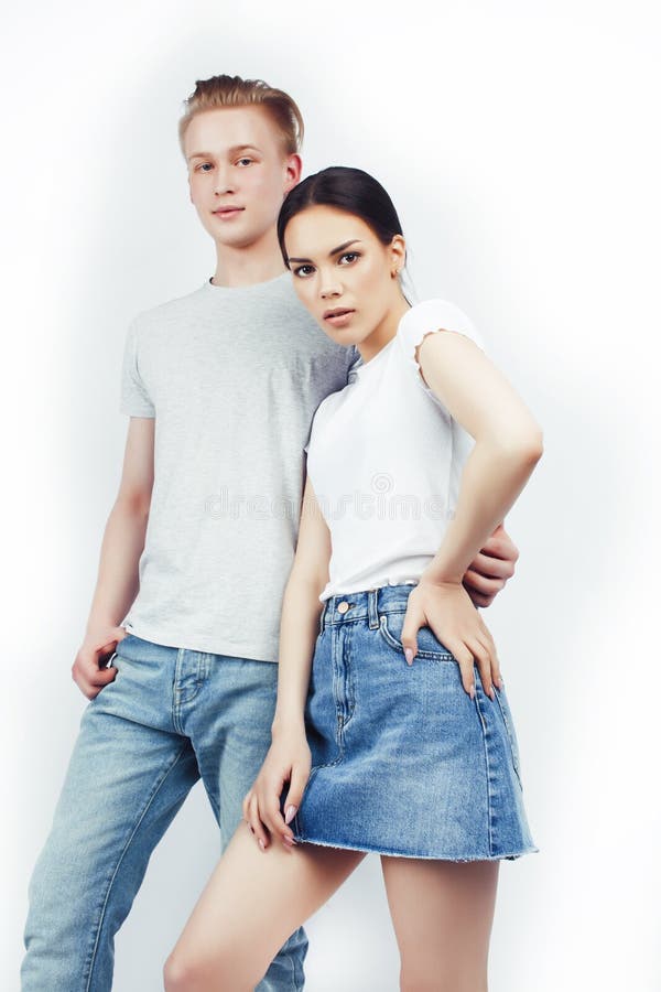 Modern hipster guys together couple diverse nations, asian girl and caucasian blond boy isolated on white background stock photography Modern hipster guys together couple diverse nations, asian girl and caucasian blond boy isolated on white background stock photography