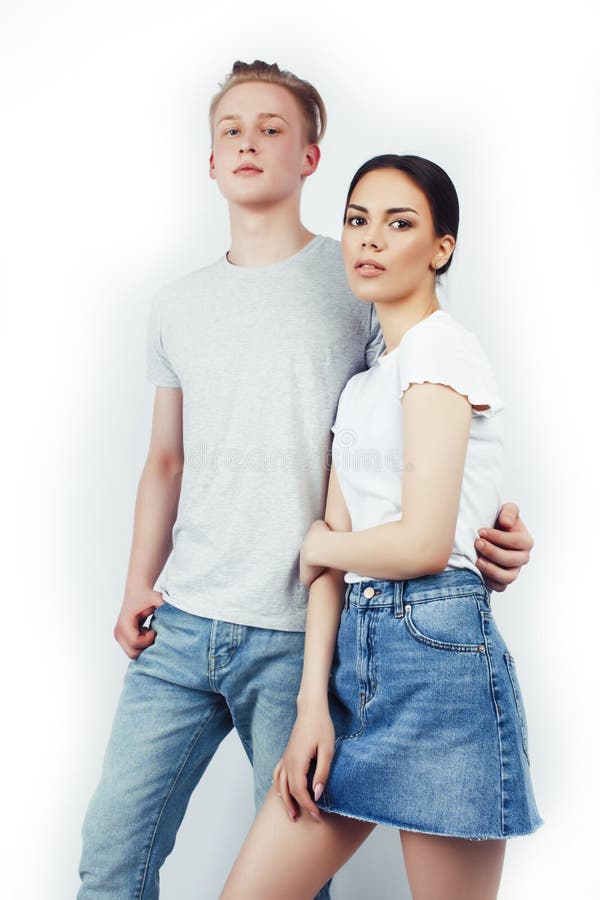 Modern hipster guys together couple diverse nations, asian girl and caucasian blond boy isolated on white background stock image Modern hipster guys together couple diverse nations, asian girl and caucasian blond boy isolated on white background stock image