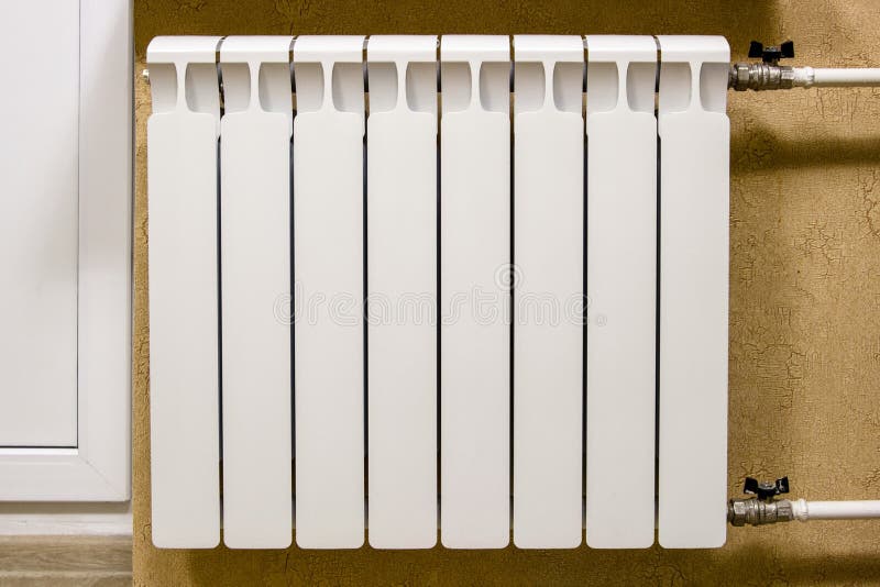 Modern home white radiator heating. Replacement, repair, installation of radiators, close-up photo.