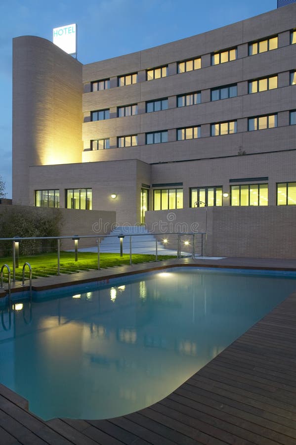 Modern hotel and swimming pool by night