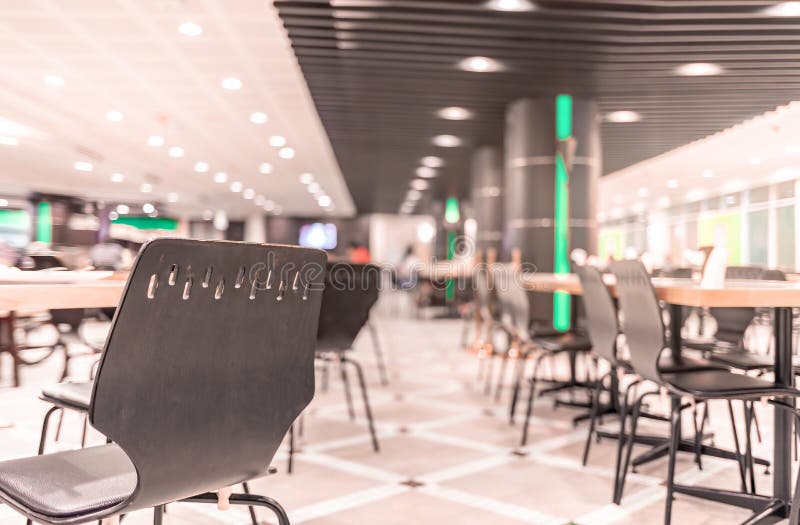 Modern interior of cafeteria or canteen with chairs and tables stock photo