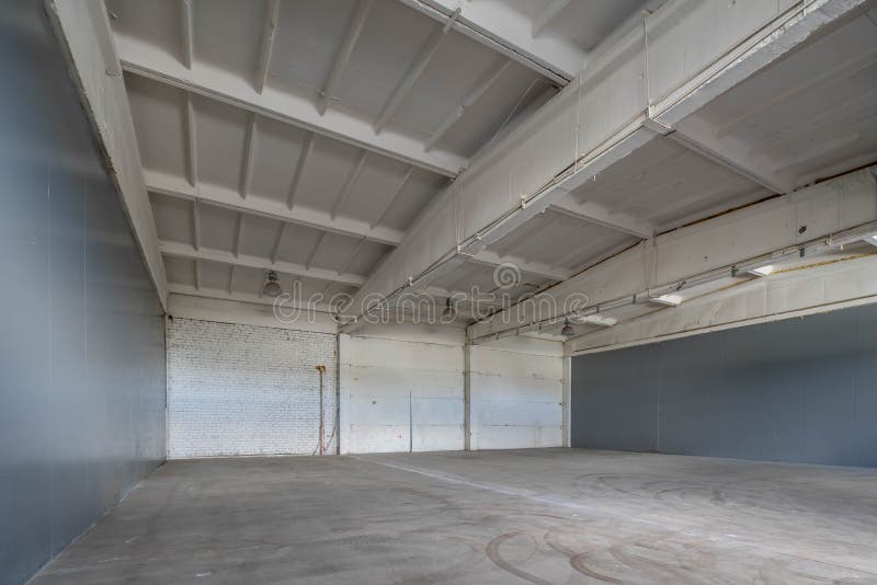 Modern Interior of Huge Empty Concrete Industrial Warehouse. Stock