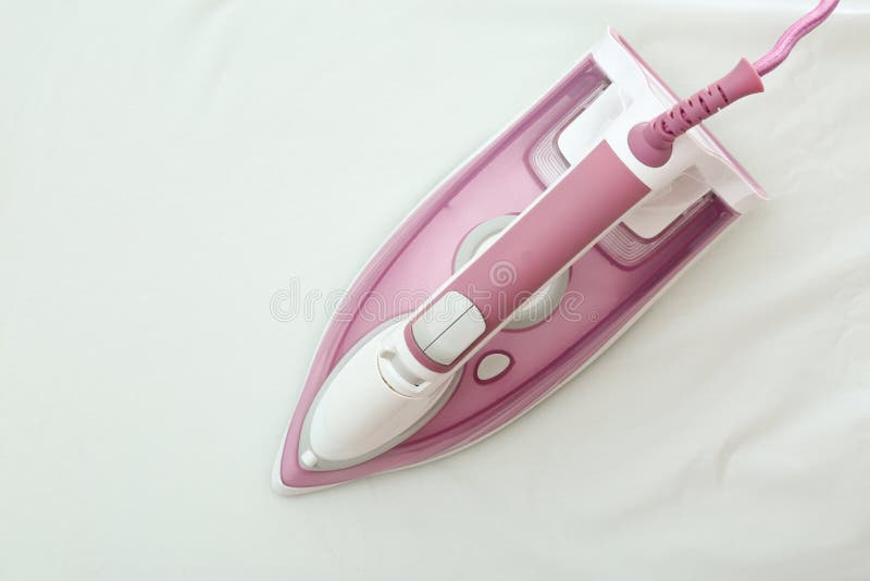 Modern iron on light fabric. Laundry day stock images