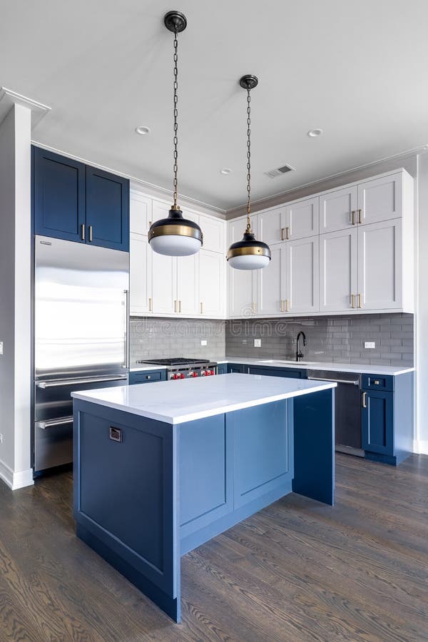 A modern kitchen with blue and white cabinets.