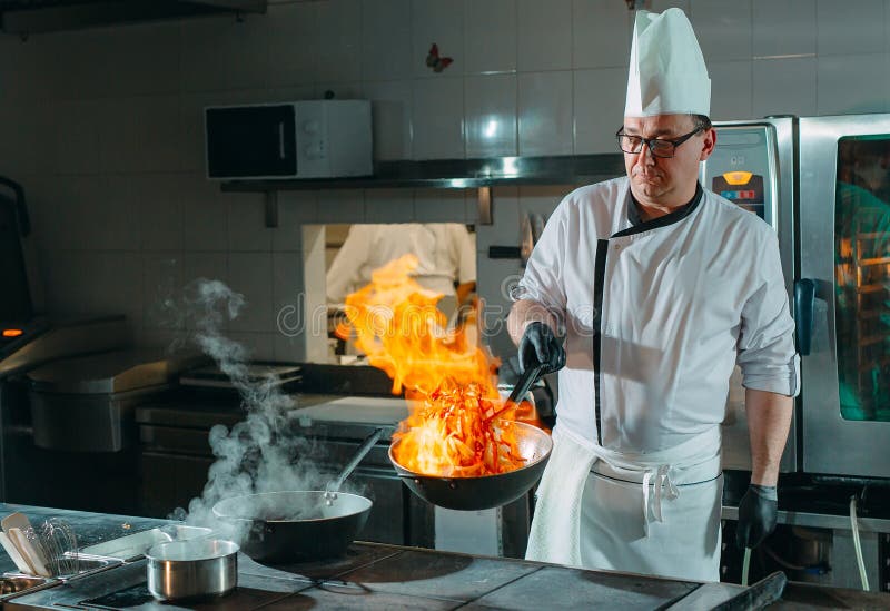 Modern Kitchen. Cooks Prepare Meals on the Stove in the Kitchen of the