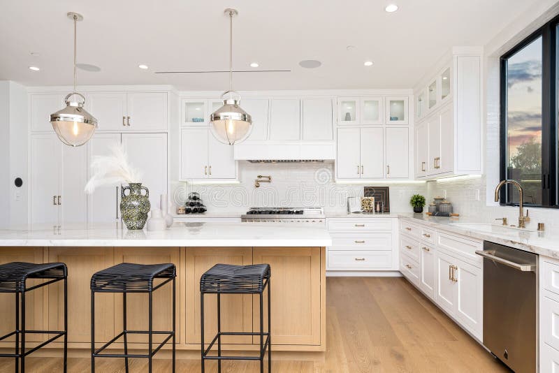 A Modern Kitchen with an Island and Two Bar Stools Editorial