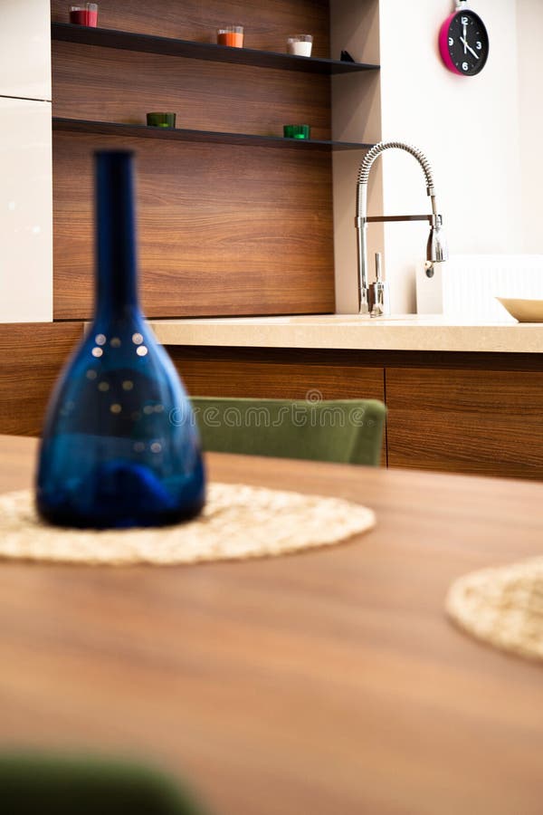 Modern Kitchen, Wooden Walnut Dining Table and Green Chairs Stock Image