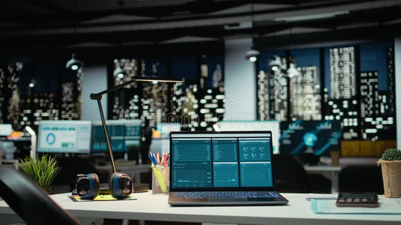 Modern laptop showcasing data reports in an empty office late at night stock footage