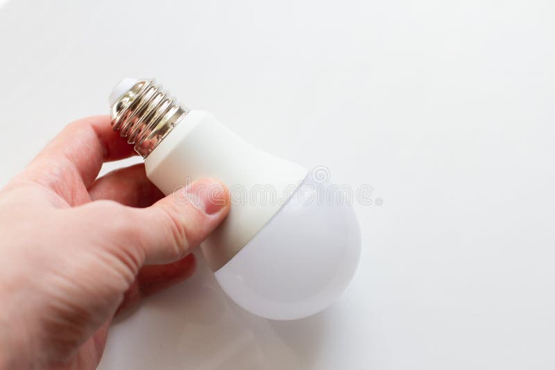 Modern LED light bulb in hand on a white background royalty free stock images Modern LED light bulb in hand on a white background royalty free stock images