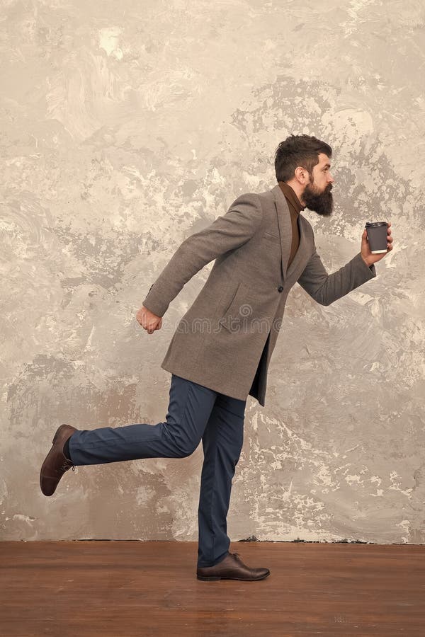 Modern life. Male fashion model. Mature businessman drink take away coffee. Brutal bearded hipster in denim wear. trendy stock photography Modern life. Male fashion model. Mature businessman drink take away coffee. Brutal bearded hipster in denim wear. trendy stock photography