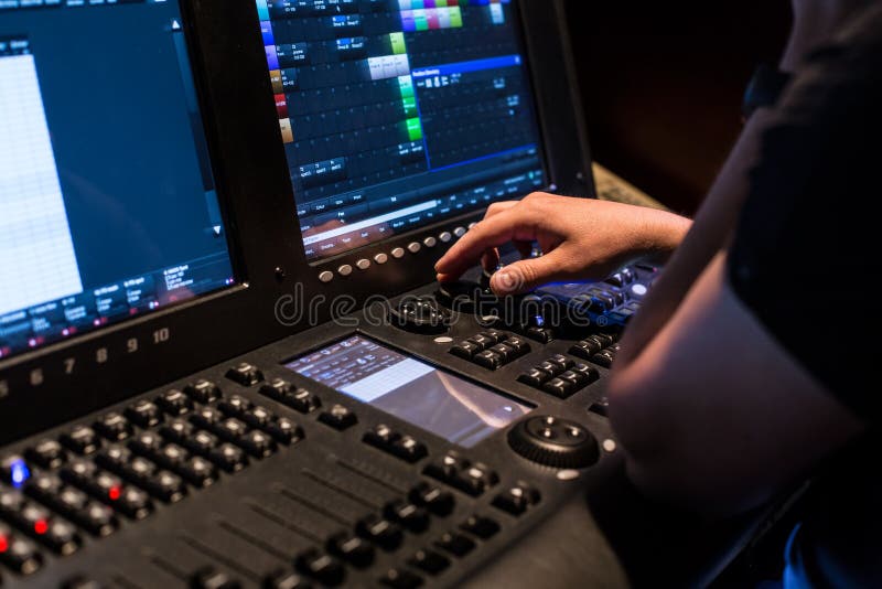 Modern light controller with operators hand stock photos