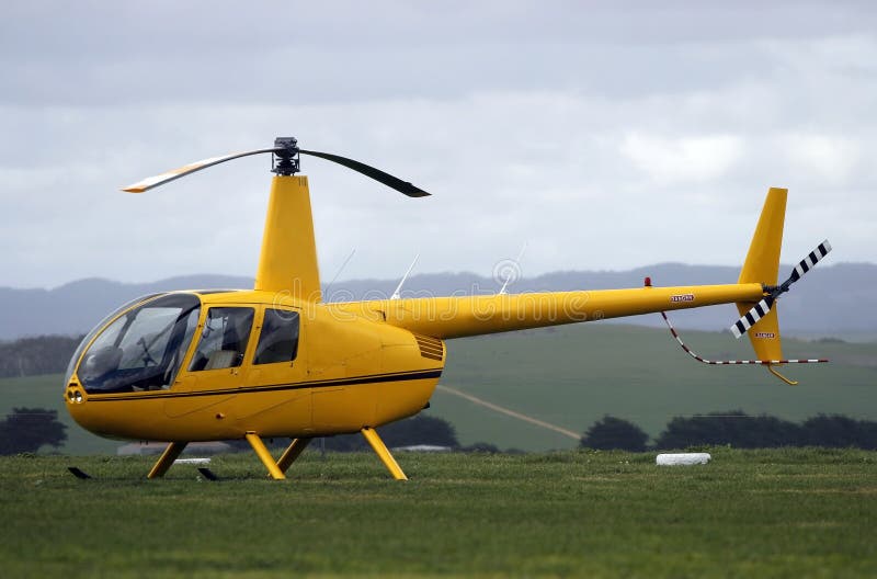 Modern light helicopter parked on grass