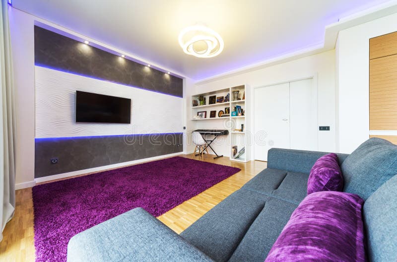 Living Room with Light Wood Panel and Hidden Lighting Stock Photo