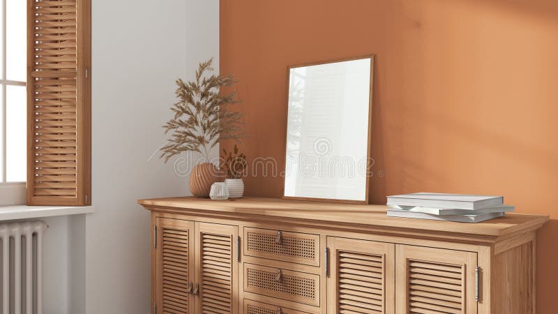 Modern living room with orange painted walls. Vintage rattan chest of drawer with vases and decors. Frame mock up. Window with