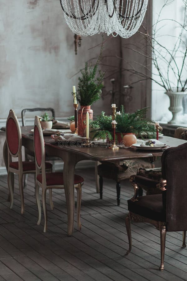 Modern loft dining room with high ceiling, vintage armchairs, empty grey concrete wall, wooden floor, dining table with stock photography Modern loft dining room with high ceiling, vintage armchairs, empty grey concrete wall, wooden floor, dining table with stock photography