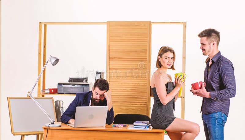 Modern lunch. Young colleagues talking during work lunch. Business partners talking on lunch break while angry colleague stock photos Modern lunch. Young colleagues talking during work lunch. Business partners talking on lunch break while angry colleague stock photos