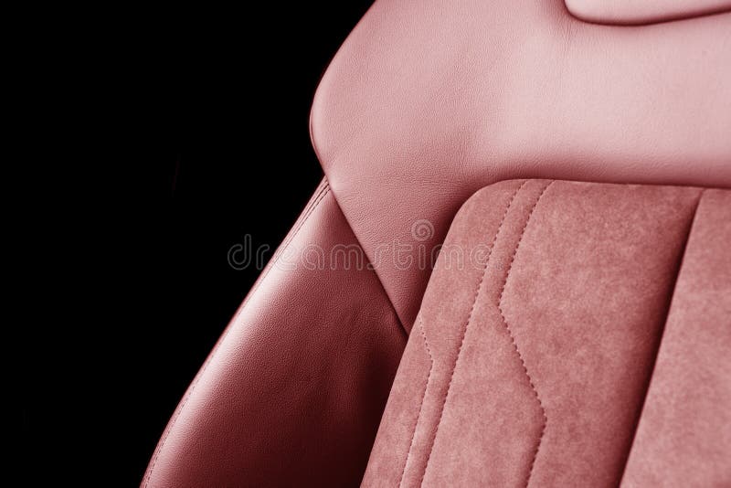 Modern luxury car red leather with alcantara interior. Part of red leather car seat details with white stitching. Interior of