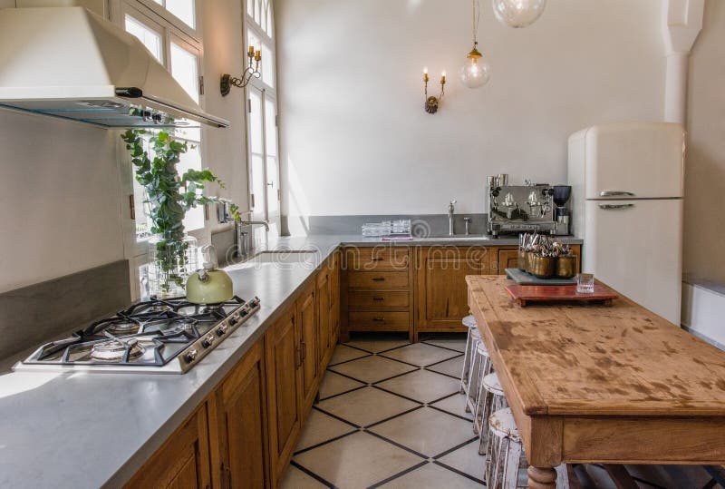 Modern Luxury Kitchen And Dining Table With French Windows Stock Photo