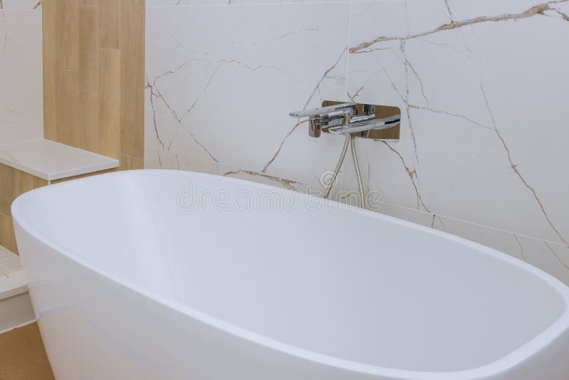 A Modern Marble Tile Bathroom with Bathtub during Stock Photo Image