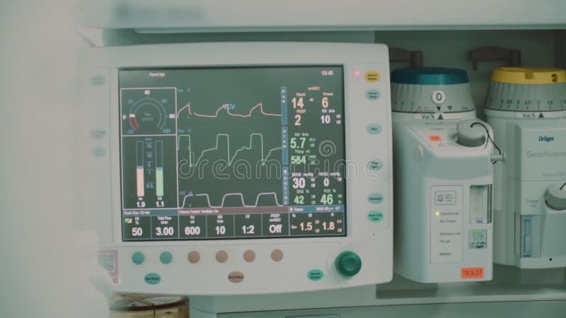 Modern medical operation room in which doctors look into monitors with biometric data about the patient during the operation