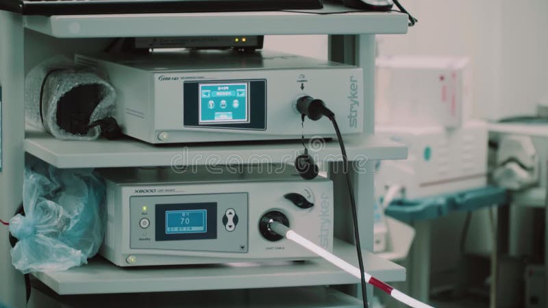 Modern medical operation room in which doctors look into monitors with biometric data about the patient during the operation