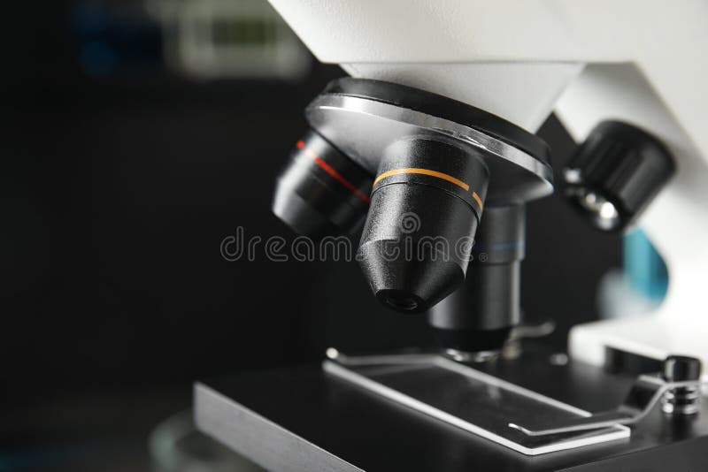 Microscope with Different Microscopes and Flasks on a Blue Background