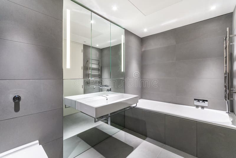 Modern minimalist bathroom in gray and white royalty free stock photography