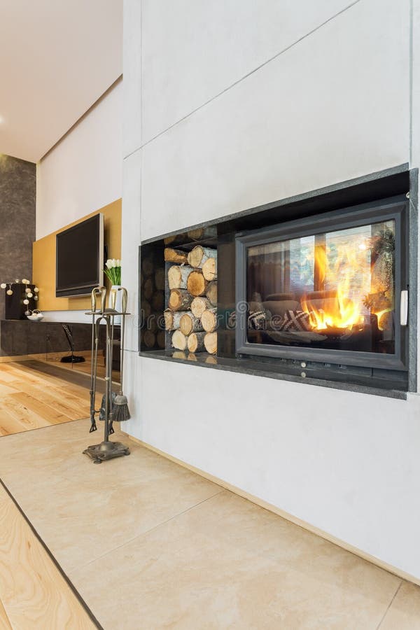 Modern minimalist fireplace in villa stock photo