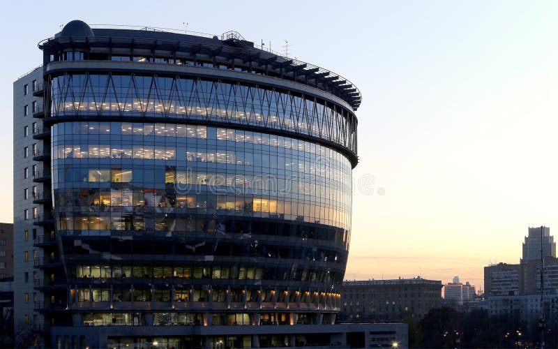 Modern office building with big windows at night