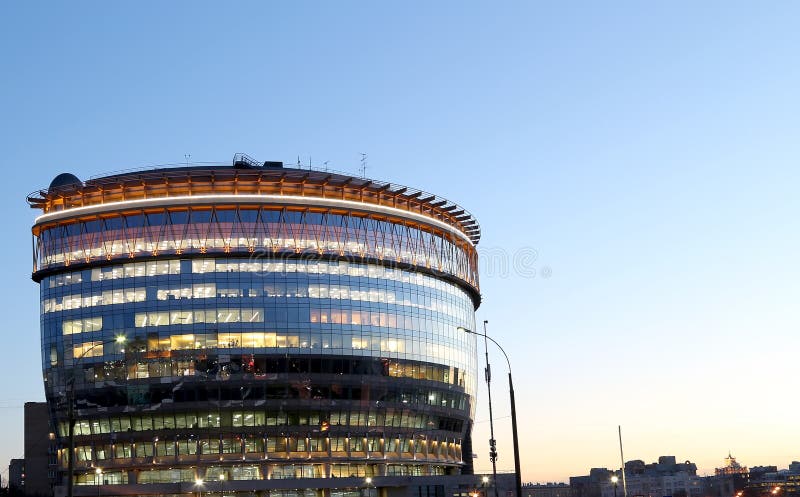 Modern office building with big windows at night