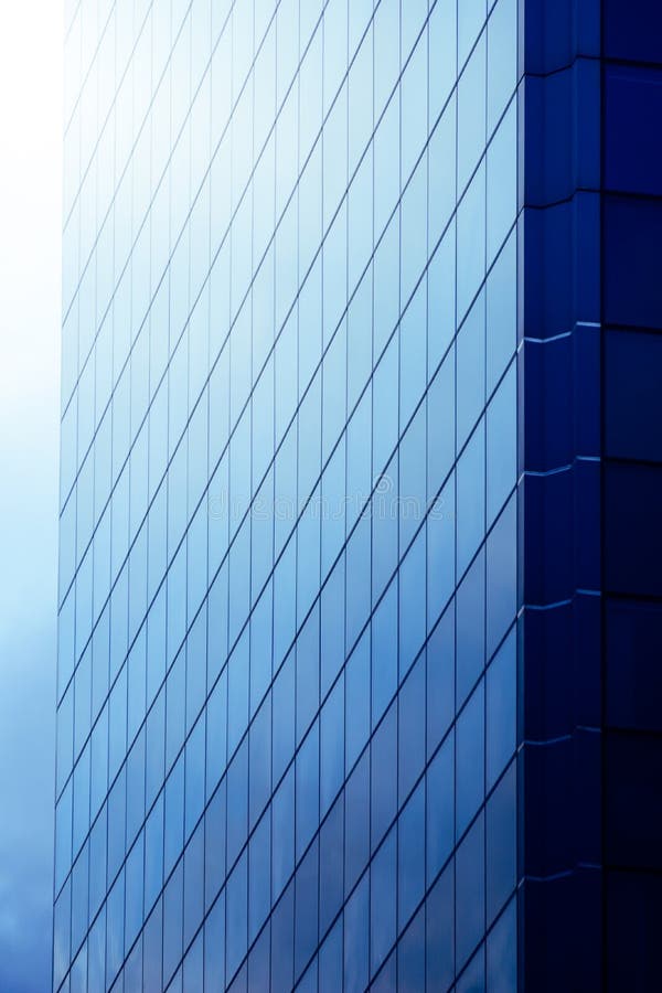Modern Blue Office Building Skyscraper with Glass Walls Vertical Photograph Stock Photo