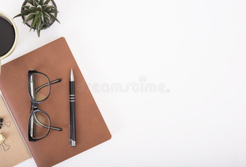 Modern Office desk with notebook, pen, paper book and coffee cup stock image Modern Office desk with notebook, pen, paper book and coffee cup stock image