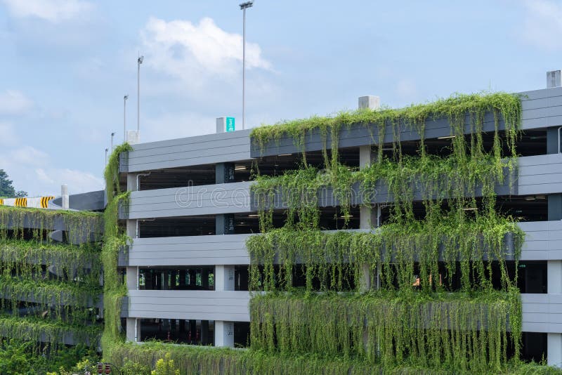 Modern parking garage building covered with plant, exterior decoration