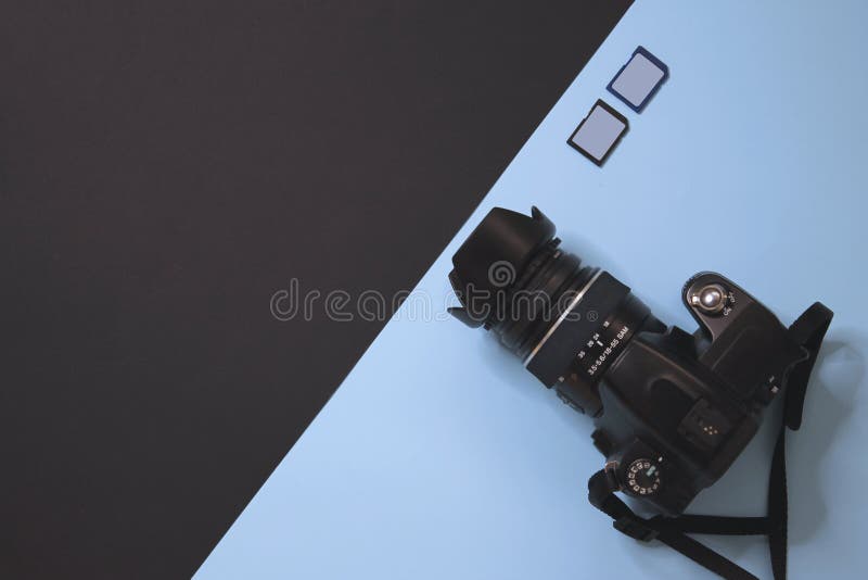 Modern photography camera and memory on black and blue background royalty free stock photo