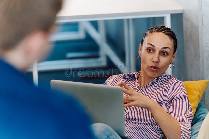 A modern programmer discussing future business projects with colleagues in a modern startup office royalty free stock photography