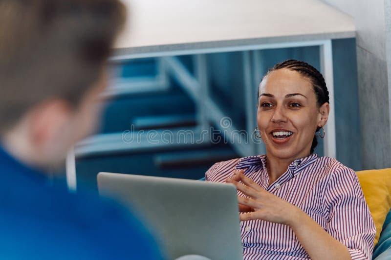 A modern programmer discussing future business projects with colleagues in a modern startup office stock image