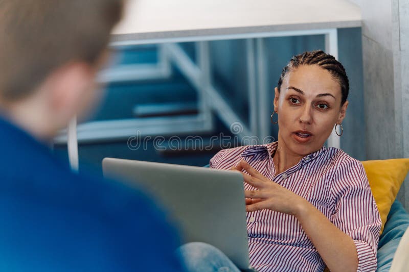 A modern programmer discussing future business projects with colleagues in a modern startup office royalty free stock photo