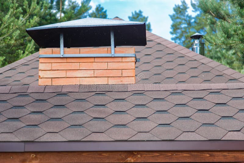 Modern roofing and decoration of chimneys. Flexible bitumen or slate shingles.